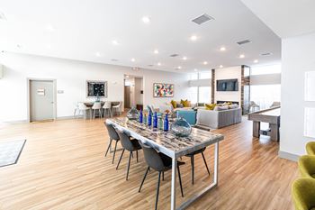 A living room with a dining room table and a couch